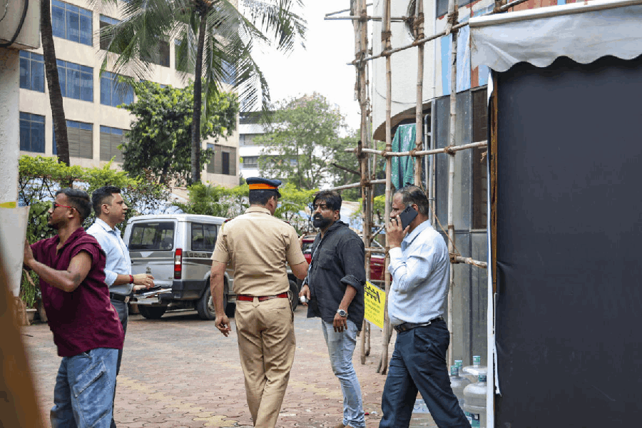 Security personnel arrive with an eyewitness for reconstruction of the crime scene as part of the ongoing probe into the children hostage case, in Mumbai, Friday, Oct. 31, 2025.