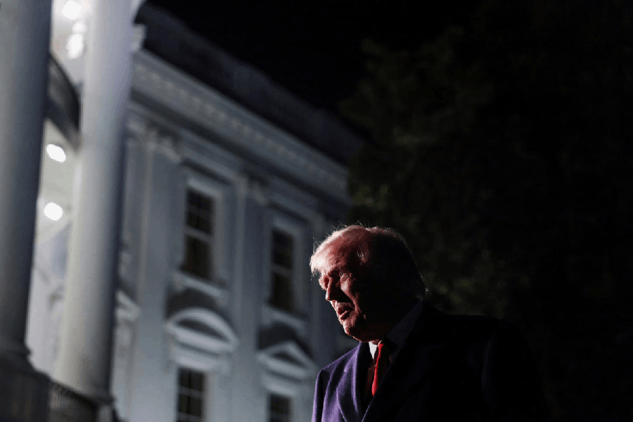 U.S. President Donald Trump speaks to members of the media (not pictured) as he departs for Asia from the South Lawn of the White House in Washington, D.C., U.S., October 24, 2025.