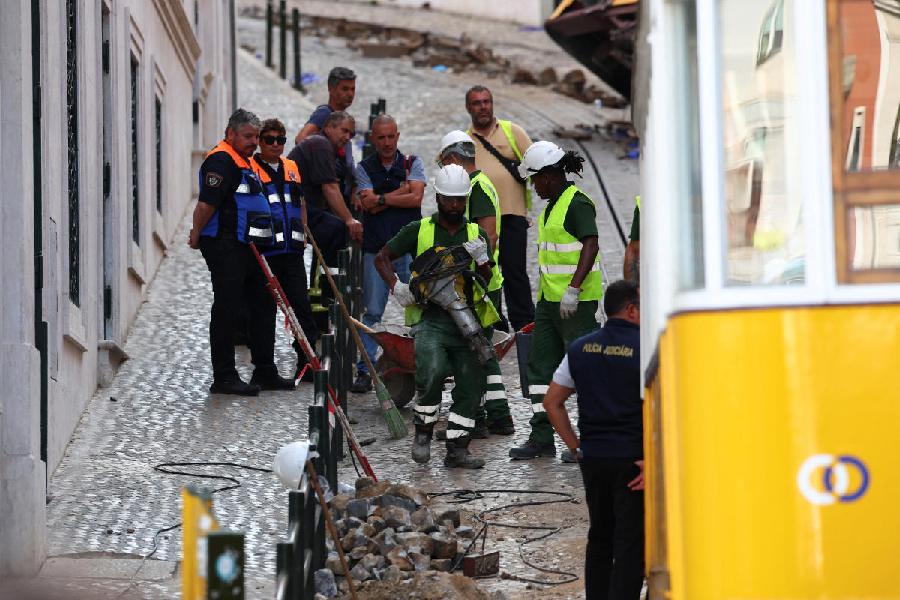 People work at the site of the accident after Gloria funicular railway car, a popular tourist attraction, derailed and crashed, resulting in multiple casualties, according to authorities, in Lisbon, Portugal, September 4, 2025.
