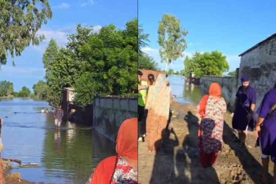 A relief team and residents amid floods in Ajnala tehsil near Amritsar on Thursday