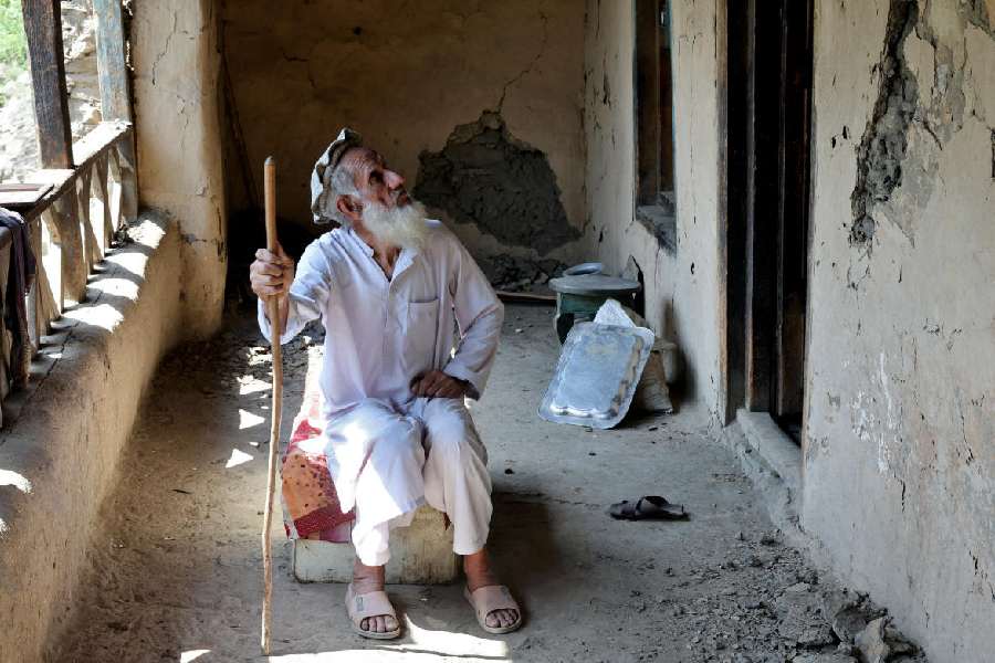 A man looks at damaged walls of his house (Reuters)