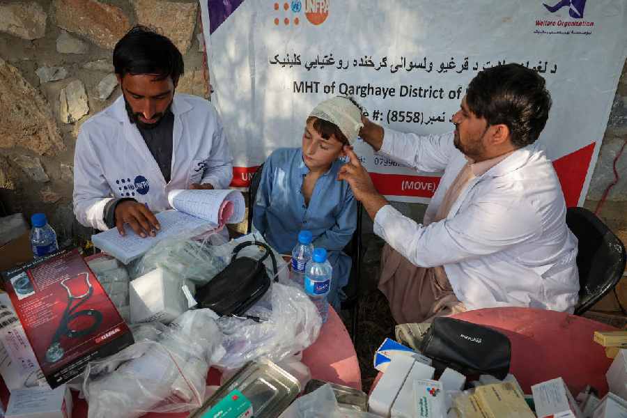 A doctor examines a victim (Reuters)