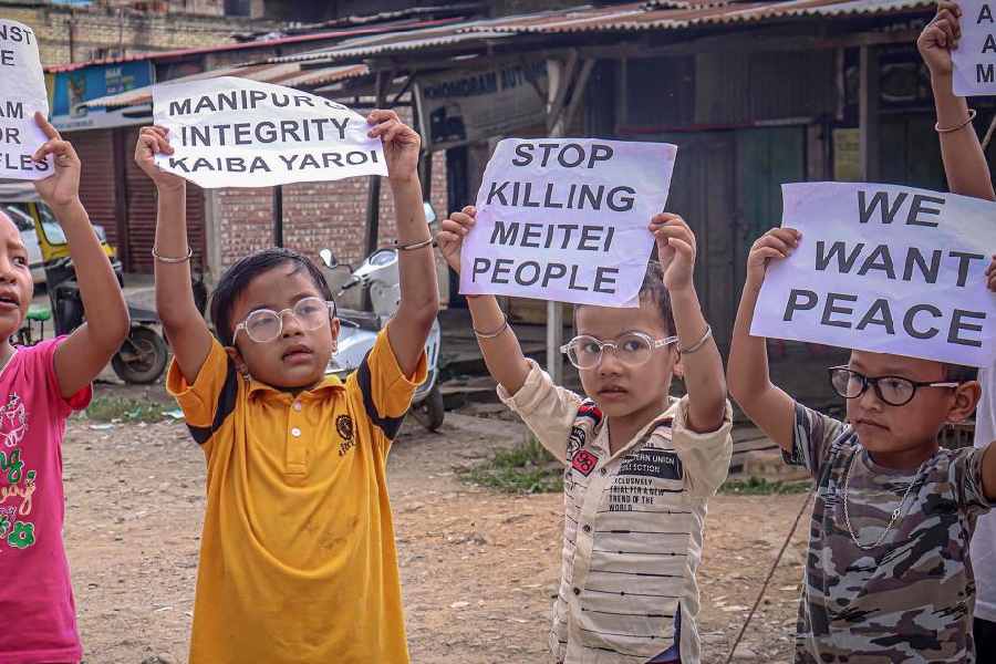 Children take part in a protest demanding restoration of peace in Manipur, in Imphal