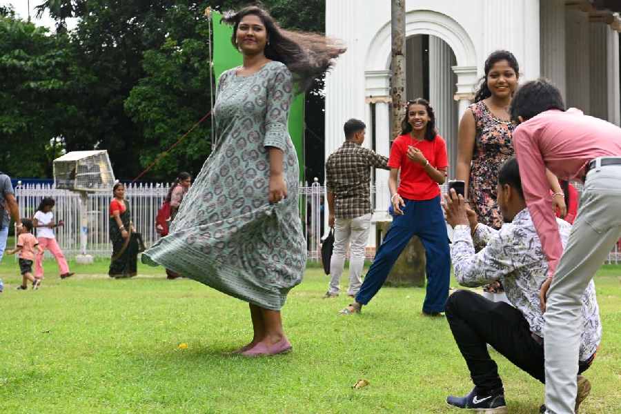 A group of young friends laughing and posing while creating reels of their fun moments at the Prinsep Ghat area, capturing lively memories on their mobile phones on Saturday evening, July 26, 2025.