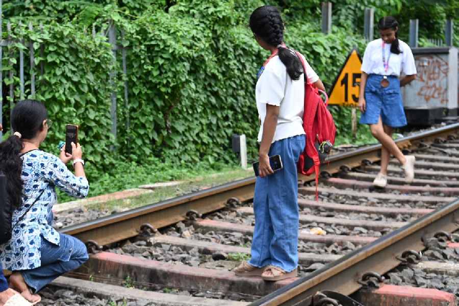 A group of youngsters posing while creating reels of their memorable moments on the train tracks at the Prinsep Ghat area, capturing lively memories on their mobile phones on Saturday evening, July 26, 2025.
