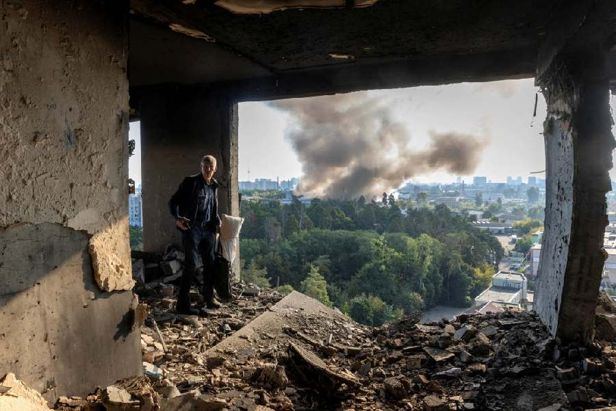 A friend of the owner inspects the damage in an apartment that was hit during a Russian drone strike(REUTERS)