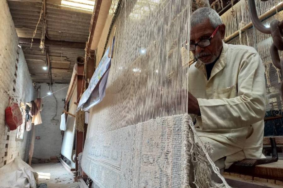 A weaver at work at a carpet factory in Bhadohi