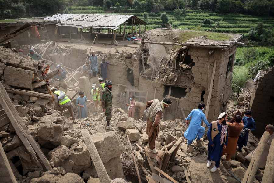 Rescue workers clear debris of a damaged house in Mazar Dara in Kunar, Afghanistan. Kunar was most affected by the August 31 earthquake.