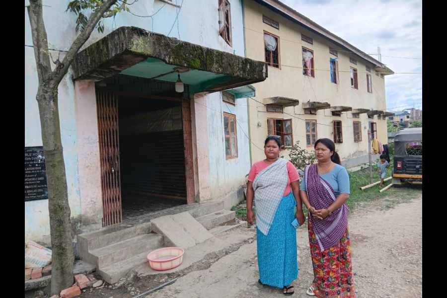 A sister duo --Laishang Thempriya (left) and Yumnam Sandhya from Moreh -- standing in front of the hostel building of the Akampat relief camp where they have been. Staying since May, 2023.