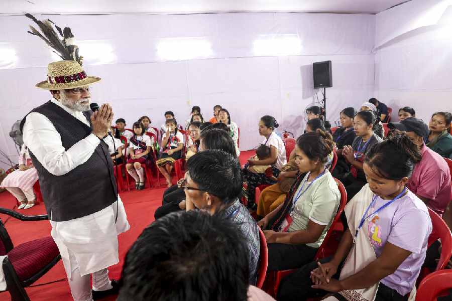 Narendra Modi speaks with displaced people in Manipur’s Churachandpur district on Saturday.