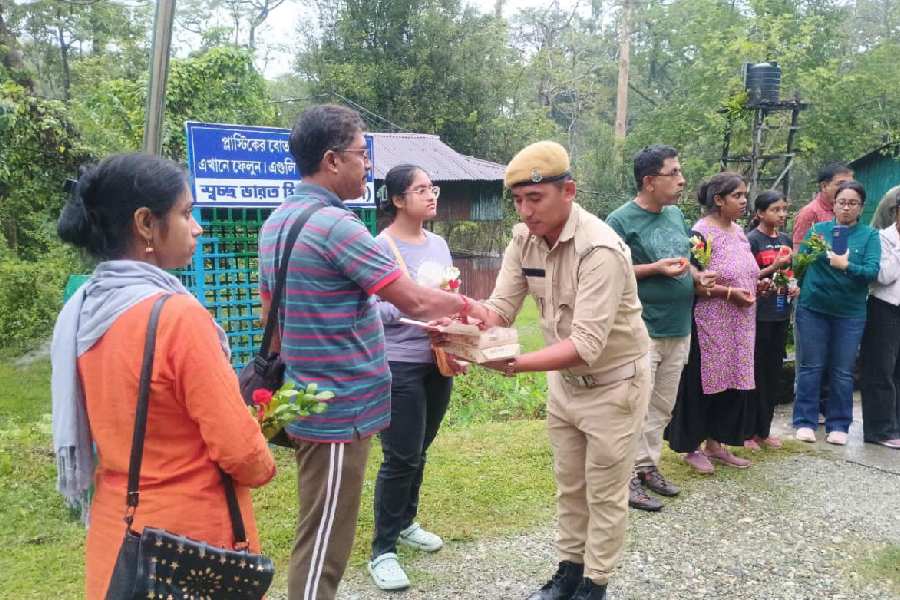 Foresters welcome tourists at the entrance to the Jaldapara National Park in Alipurduar on Tuesday. The park reopened for visitors after three months