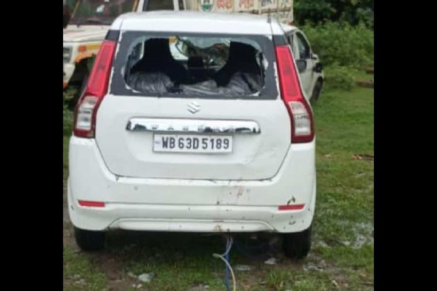 The car that fell off the road at Chilkirhat in Cooch Behar district early on Tuesday morning.