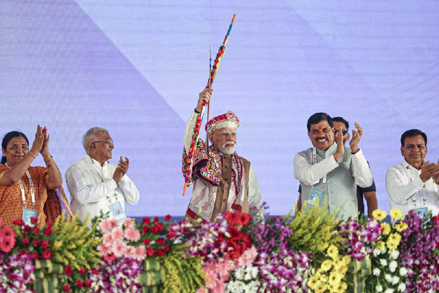 Prime Minister Narendra Modi holds a bow and arrow at the rally in Dhar, Madhya Pradesh, on Wednesday.
