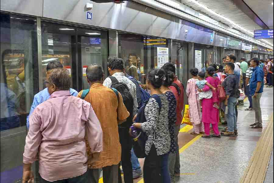Commuters at the metro station, in Kolkata.