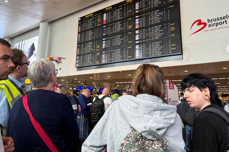 Travellers wait at Brussels airport, after a cyberattack at a service provider for check-in and boarding systems disrupted operations at several major European airports, in Zaventem near Brussels, Belgium September 20, 2025.