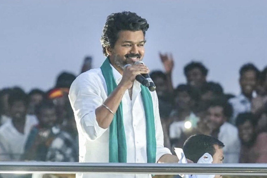 Actor and Tamilaga Vettri Kazhagam (TVK) founder Vijay greets the gathering during a public meeting, in Thiruvarur district, Tamil Nadu, Saturday, Sept. 20, 2025.