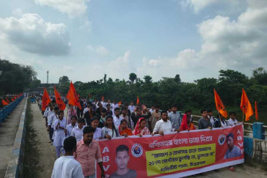 School students take a rally organised by ABVP to observe Bengali Language Day in memory of deceased Rajesh Sarkar and Tapash Barman at Daribhit village on Saturday