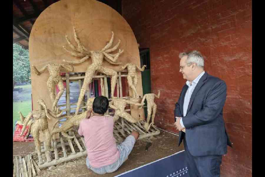 Tim Curtis watches the making of a Durga idol on the verandah