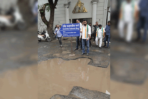 The Youth Congress protesting in front of large potholes (Pic: Sourced by the correspondent)
