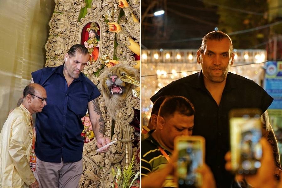 The Great Khali, the towering Indian professional wrestler, drew immense attention at the pandal, his larger-than-life appearance matching the grandeur of the festival