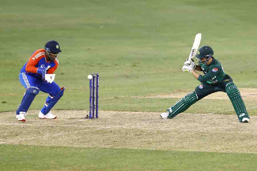 Pakistan's Salman Ali Agha in action with India's Sanju Samson.