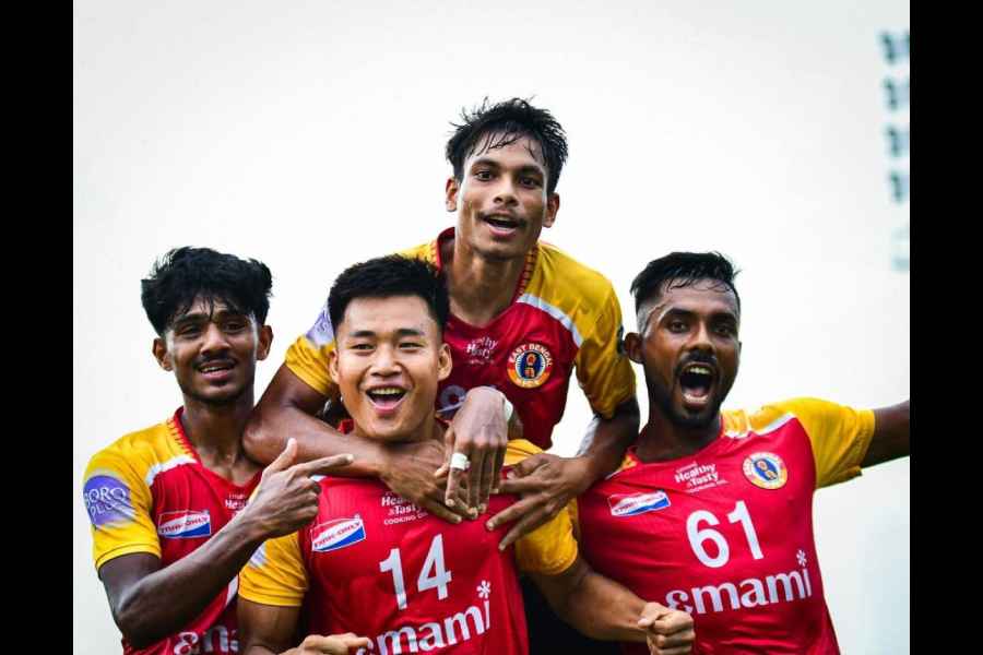 East Bengal players congratulate David Lalhlansanga (shirt No 14) after he scored the first goal against United Sports Club at the club ground on Monday.