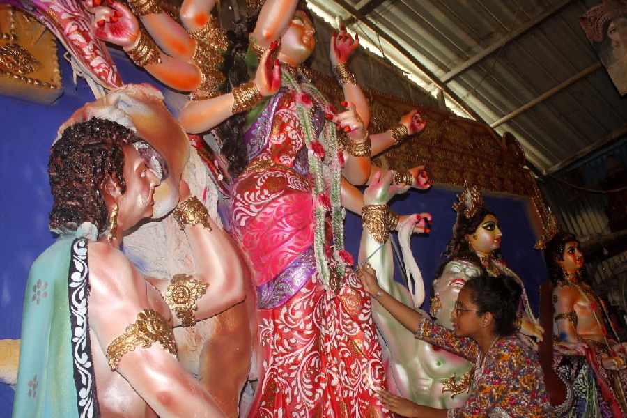 Sushmita Paul beautifies a Durga idol at Siliguri Kumartuli on Tuesday