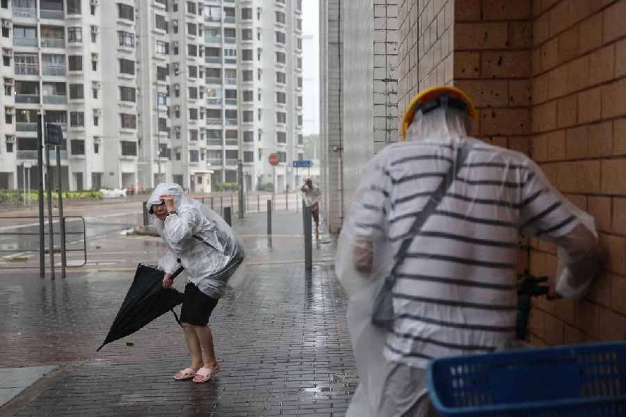 People brave strong winds as Super Typhoon Ragasa approaches, in Hong Kong, China, September 24, 2025.