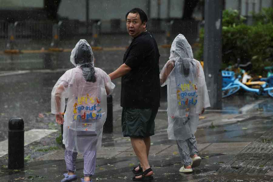 People brave strong wind and rain as Super Typhoon Ragasa approaches Shenzhen, Guangdong Province, China, September 24, 2025.