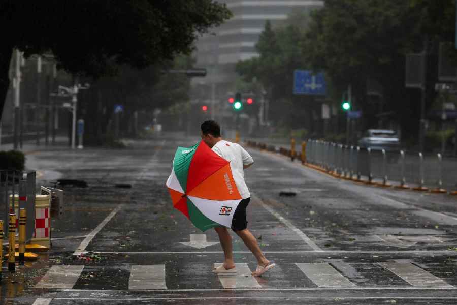 A person braves strong wind and rain as Super Typhoon Ragasa approaches in Shenzhen, Guangdong Province, China September 24, 2025.