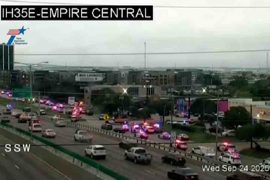 Police cars and ambulances stand outside a ICE facility where a shooting took place in Dallas, Texas, U.S. September 24, 2025 in this screengrab taken from a handout traffic camera video.