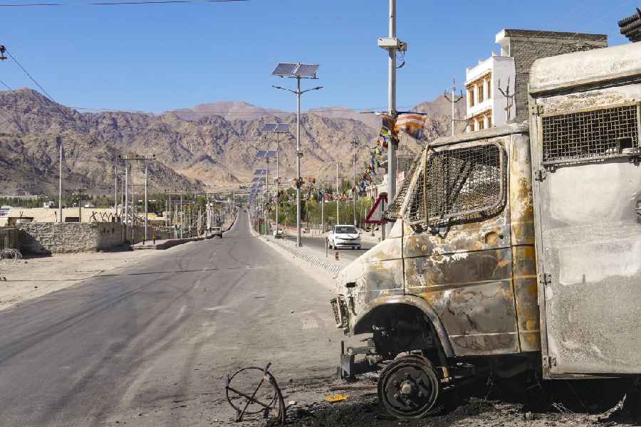 Charred remains of a vehicle lies in the aftermath of violent clashes between demonstrators and police during a protest demanding statehood for Ladakh, outside BJP headquarters building, in Leh, Thursday, Sept. 25, 2025.