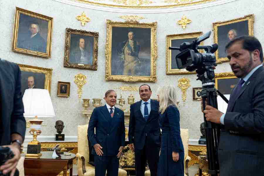 Pakistan Prime Minister Muhammad Shehbaz Sharif, left, and Gen. Syed Asim Munir wait for their meeting with President Donald Trump, in the Oval Office at the White House, Thursday, Sept. 25, 2025, in Washington.
