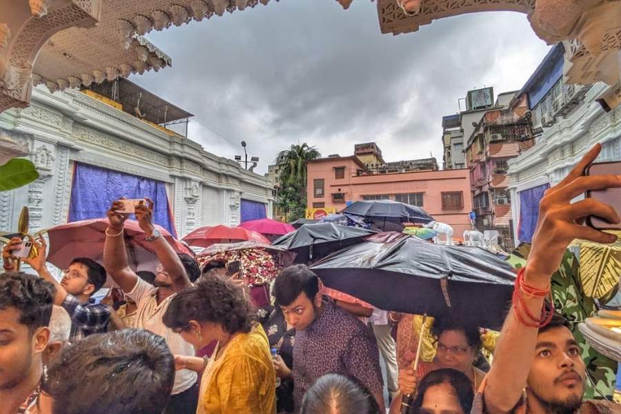 The crowd takes cover at the Sreebhoomi puja
