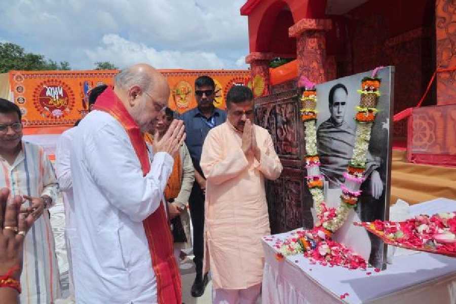 Amit Shah pays tribute to a portrait of Bengali polymath Ishwarchandra Vidyasagar at EZCC in Salt Lake before inaugurating a Durga Puja there on Friday