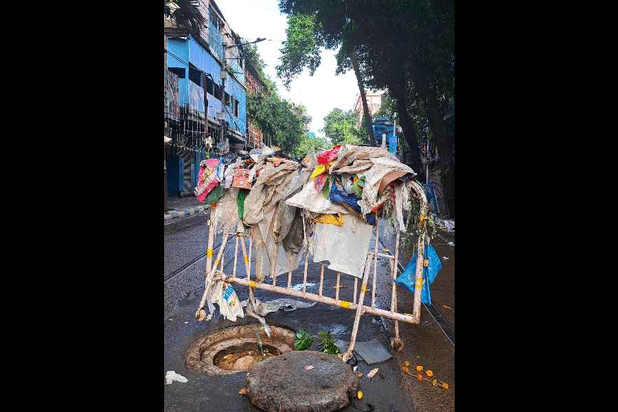 Plastic waste, lifted from manholes, slung over a KMC guardrail at Surya Sen Street in Sealdah on Wednesday.