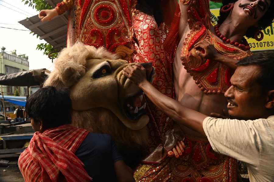In Kumartuli, people load idols onto a truck on Saturday morning.