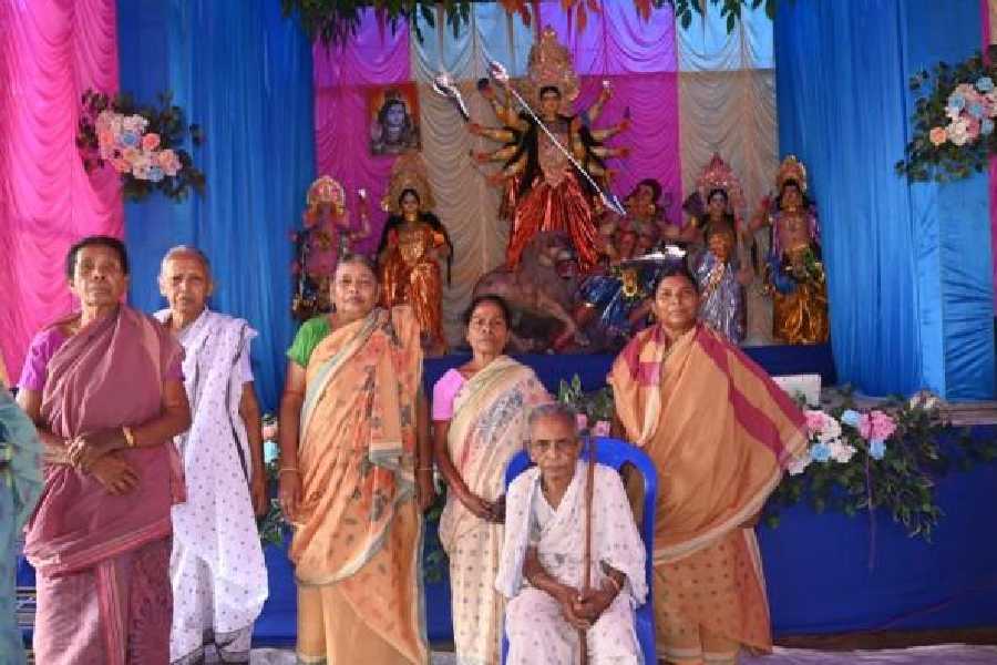 Elderly women at Oboseshe pose with the Durga idol in Adra, Purulia district