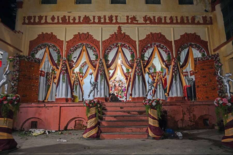 The five-arched ‘thakurdalan’ of the Basumallik Bari in Pataldanga, adorned with flowers and drapes, where Durga Puja has been celebrated since 1831