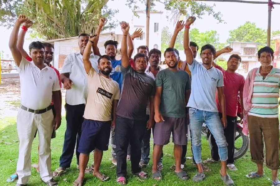 Some of the migrant workers who organise the Durga Puja and the ‘bhandara’ in Paharpur under the Chanchal subdivision of Malda district.
