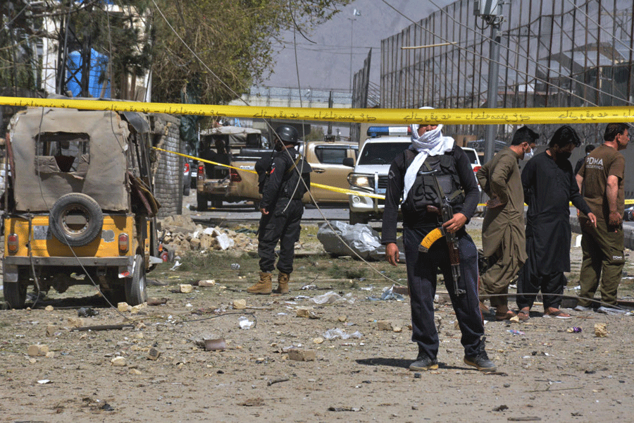 Security officials examine damaged vehicles at the site of a powerful car bombing, in Quetta, Pakistan, Tuesday, Sept. 30, 2025.