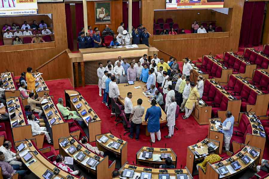 Opposition MLAs stage a protest inside the House in Bhubaneswar on Tuesday. 