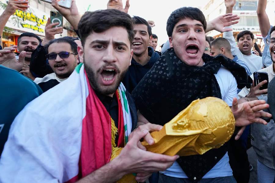 Football fans take to the streets of the enclave in Baghdad, Iraq, Wednesday, April 1, 2026, after the Iraq soccer team beat Bolivia in a World Cup 2026 playoff final.