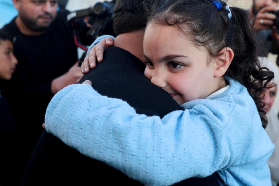 A Palestinian child, who was evacuated as a premature baby during the two-year Israeli offensive for medical treatment in Egypt, is carried by a male relative outside a bus after returning to Khan Younis in the southern Gaza Strip, March 30, 2026.