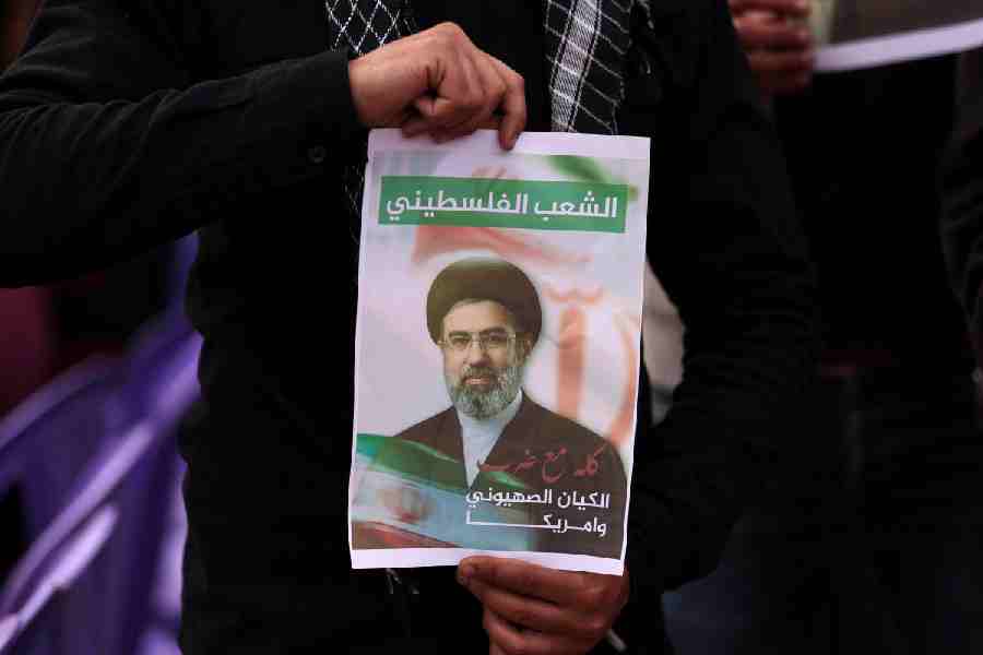 A Palestinian holds an image depicting Iran\\\'s new Supreme Leader Mojtaba Khamenei, as they take part in a rally on the al-Quds Day (Jerusalem Day), in Gaza City, March 13, 2026.
