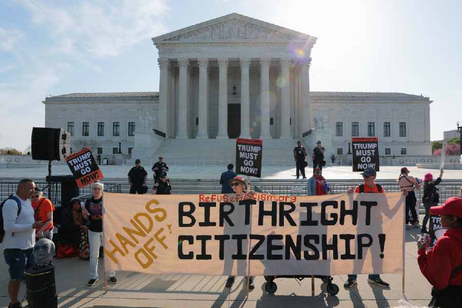 Demonstrators hold signs outside the U.S. Supreme Court building on the day the court is expected to hear oral arguments on the legality of the Trump administration's effort to limit birthright citizenship for the children of immigrants, in Washington, D.C., US, April 1, 2026