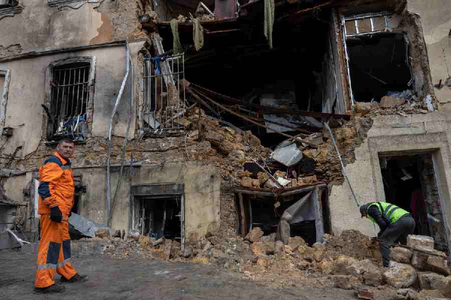 Municipal workers clear the rubble of residential building damaged after a Russian drone strike in Odesa, Ukraine, on Thursday, March 19, 2026.