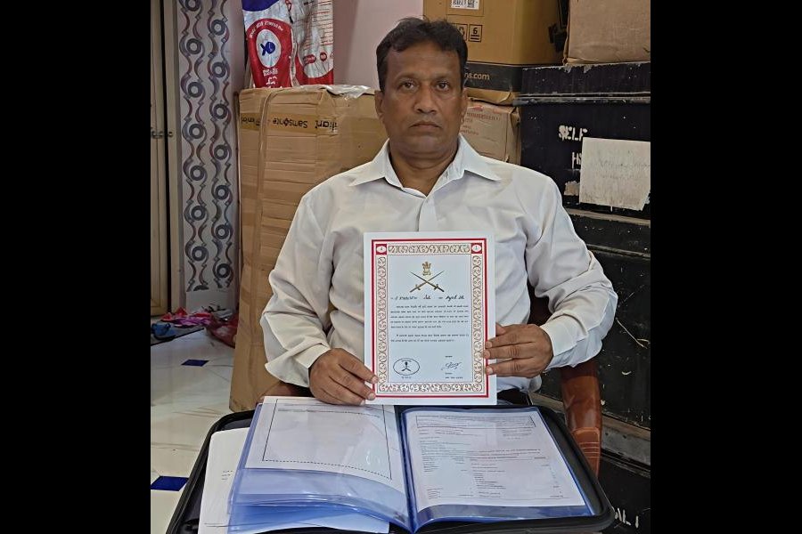 Azad Ali holds up an army citation at his home in Baduria on Wednesday. Picture by Pashupati Das