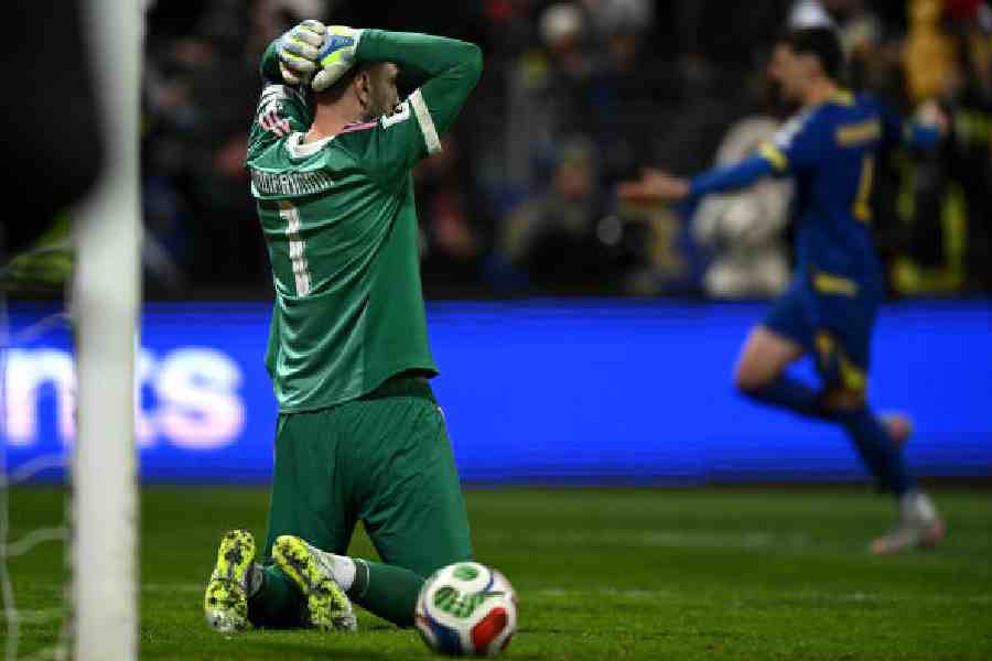 Italy goalkeeper Gianluigi Donnarumma falls on his knees with hands on his head after Bosnia Herzegovina won Tuesday's 2026 World Cup European qualifier knock-out playoff match at Stadion Bilino Polje in Zenica.