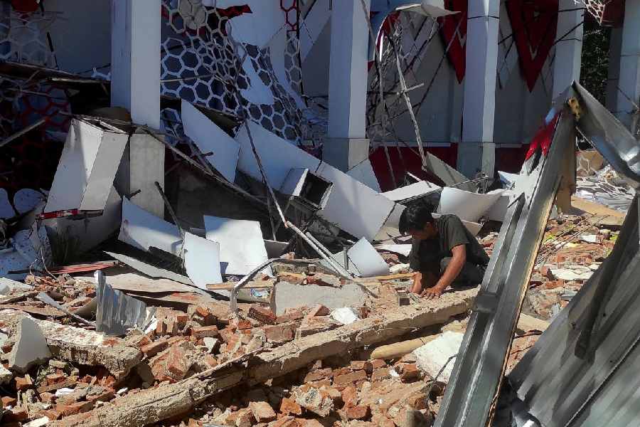 A man inspects debris at the site of a damaged building following an earthquake in Manado, North Sulawesi province, Indonesia, April 2, 2026.